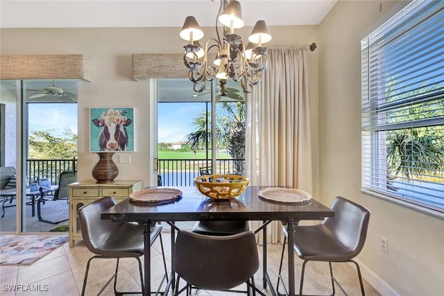 dining space featuring light tile patterned floors, baseboards, and a notable chandelier