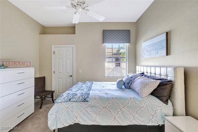 bedroom featuring light colored carpet and a ceiling fan