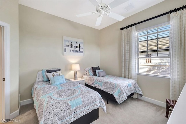 bedroom featuring visible vents, a ceiling fan, baseboards, and carpet floors