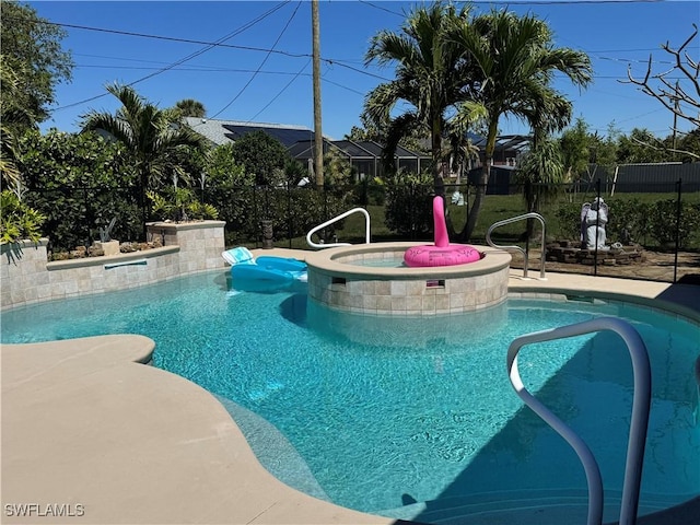 outdoor pool featuring an in ground hot tub and fence