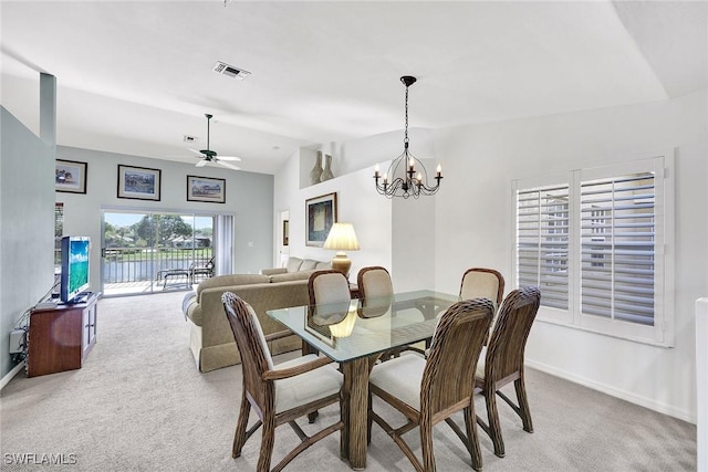 dining room featuring visible vents, baseboards, light colored carpet, vaulted ceiling, and ceiling fan with notable chandelier