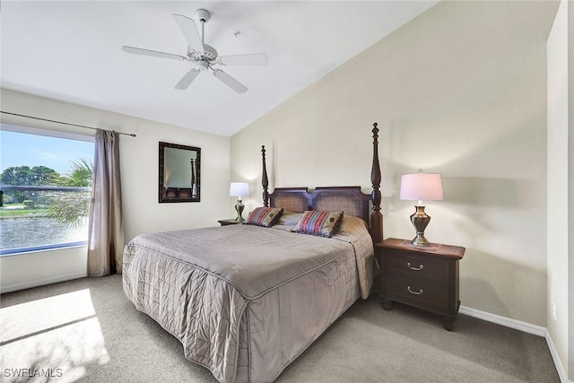 bedroom with lofted ceiling, a ceiling fan, baseboards, and light carpet