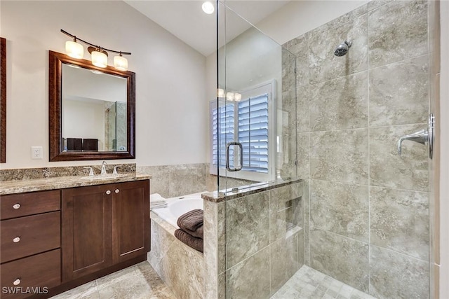 bathroom featuring a garden tub, a stall shower, and vanity