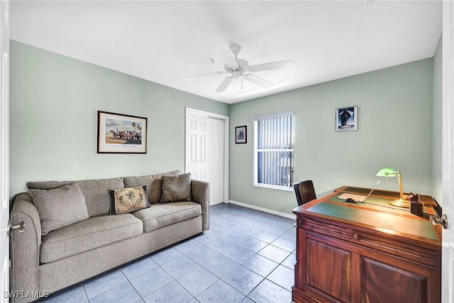 office area featuring light tile patterned flooring, baseboards, and ceiling fan