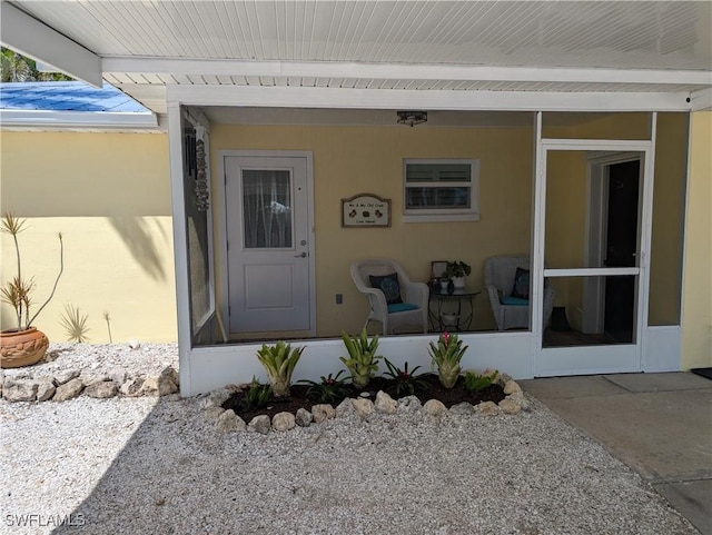 doorway to property with stucco siding