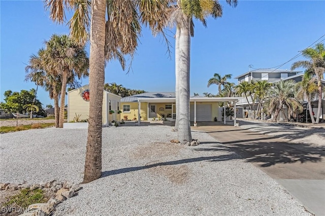 view of front facade with a carport, driveway, and a garage