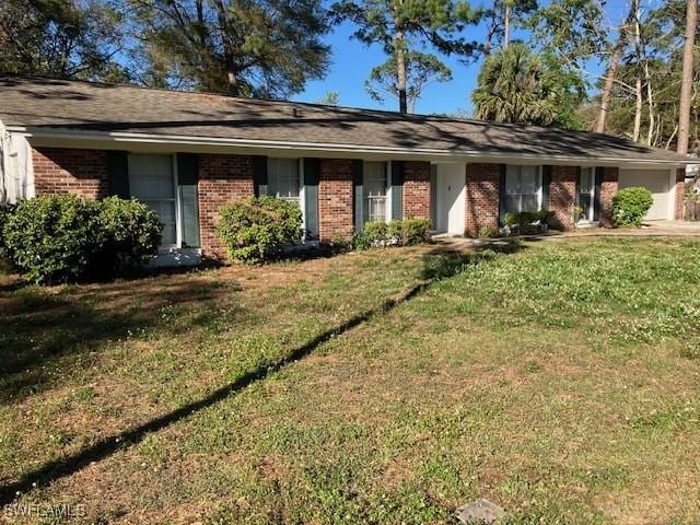 ranch-style house with brick siding and a front lawn