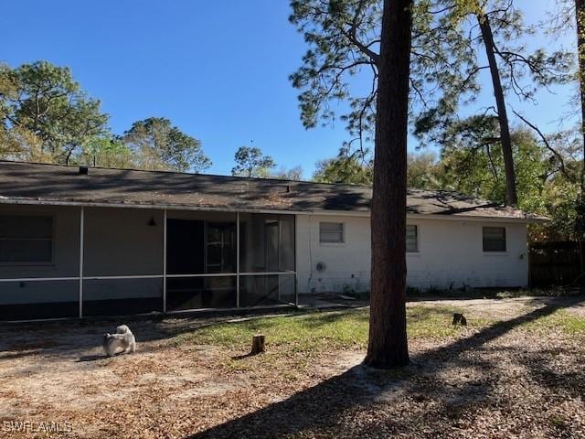 rear view of property with a sunroom