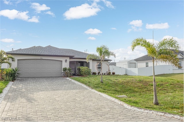 single story home featuring stucco siding, decorative driveway, a front lawn, and an attached garage