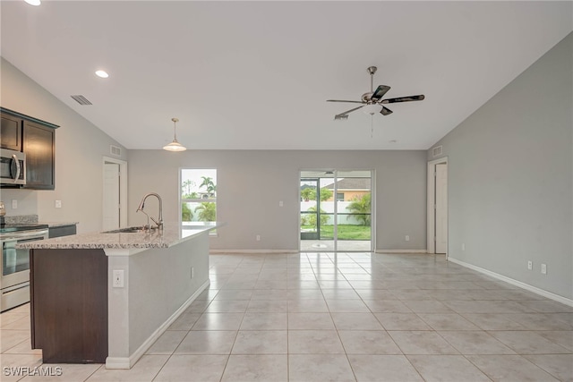 kitchen with visible vents, light tile patterned flooring, a sink, vaulted ceiling, and appliances with stainless steel finishes