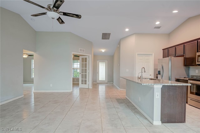 kitchen with visible vents, ceiling fan, a center island with sink, stainless steel appliances, and a sink