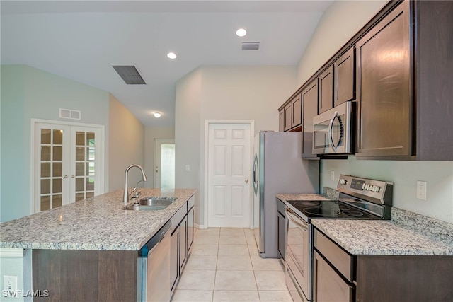 kitchen with visible vents, a sink, dark brown cabinetry, french doors, and appliances with stainless steel finishes