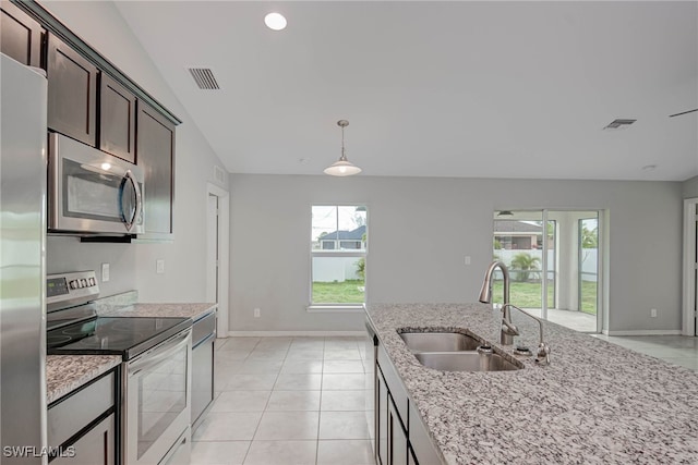 kitchen featuring visible vents, dark brown cabinets, appliances with stainless steel finishes, and a sink