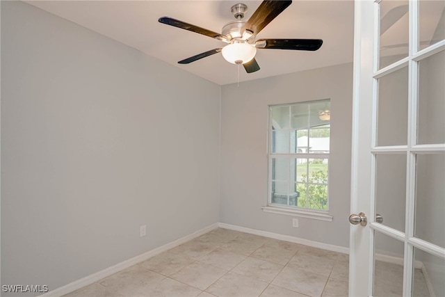 unfurnished room with light tile patterned floors, french doors, baseboards, and ceiling fan