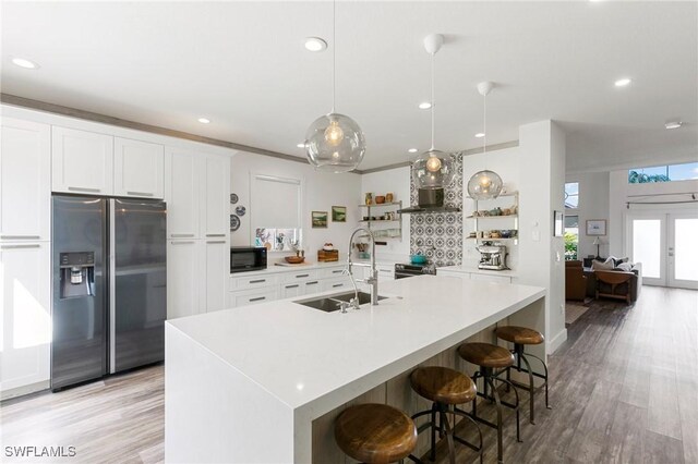 7430 Meldin Ct, Naples, FL 34104 - kitchen featuring stainless steel fridge, a sink, black microwave, open shelves, and light countertops