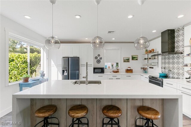 7430 Meldin Ct, Naples, FL 34104 - kitchen with appliances with stainless steel finishes, exhaust hood, a sink, a large island with sink, and recessed lighting