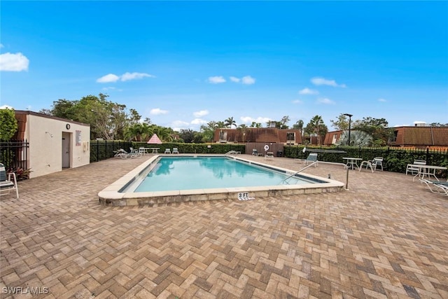 pool featuring a patio area and fence