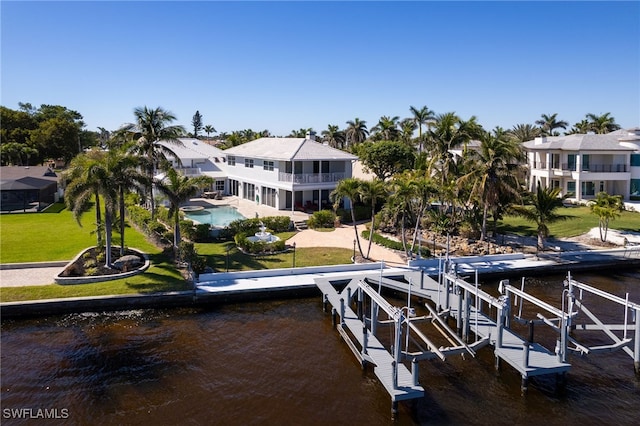 view of dock with boat lift, a lawn, and a water view