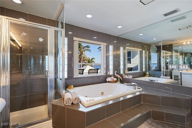 full bathroom with visible vents, a stall shower, vanity, and a whirlpool tub