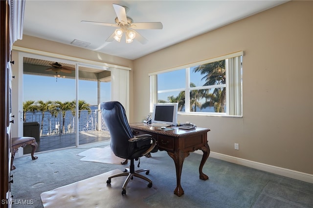 office space with visible vents, baseboards, carpet, and ceiling fan