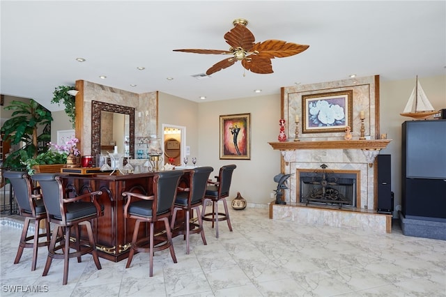 bar with a ceiling fan, visible vents, a fireplace, a dry bar, and marble finish floor