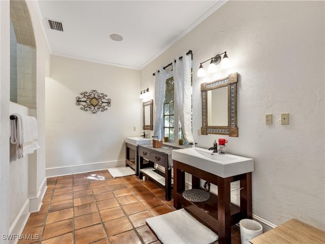 bathroom featuring visible vents, two vanities, ornamental molding, a sink, and baseboards