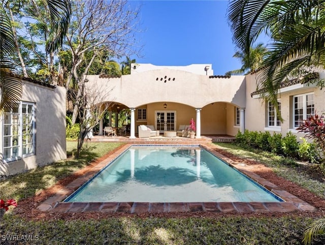 pool with french doors and a patio