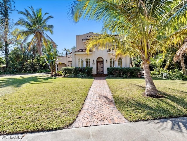 mediterranean / spanish-style house with a front lawn and stucco siding