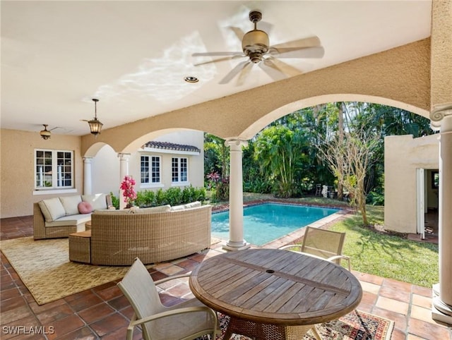 outdoor pool with an outdoor living space, a patio, and ceiling fan