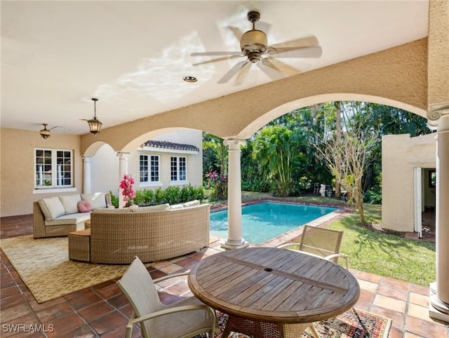 pool with a patio area, an outdoor living space, and a ceiling fan
