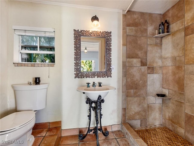 full bath with toilet, tiled shower, a wealth of natural light, and ornamental molding
