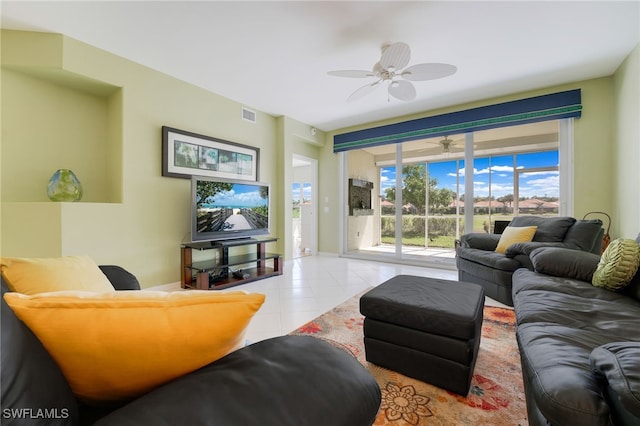 tiled living room featuring a ceiling fan and visible vents