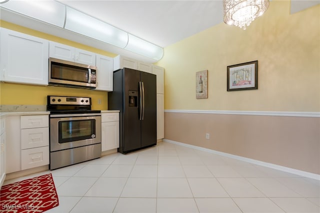 kitchen with light countertops, white cabinets, baseboards, and stainless steel appliances