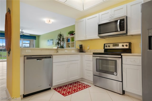 kitchen featuring light countertops, white cabinets, a peninsula, and stainless steel appliances