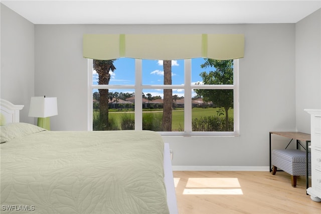 bedroom with baseboards and light wood-style floors