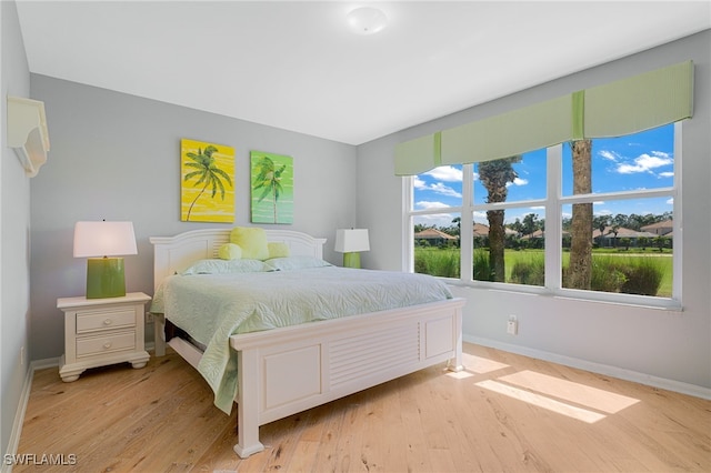 bedroom featuring baseboards and light wood-type flooring