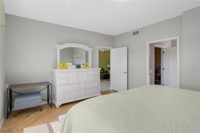 bedroom featuring light wood finished floors and visible vents