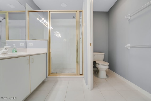 bathroom with vanity, baseboards, a shower stall, tile patterned floors, and toilet