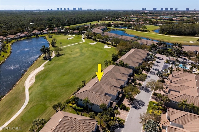 bird's eye view with a water view and view of golf course