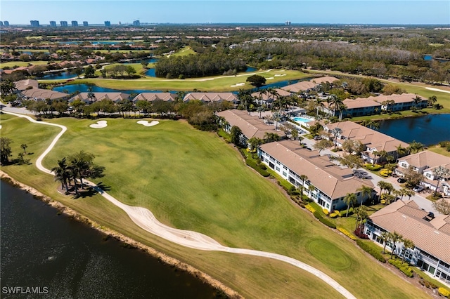 drone / aerial view with a water view and golf course view