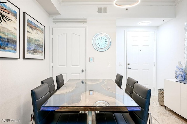 dining space with light tile patterned floors, visible vents, and crown molding