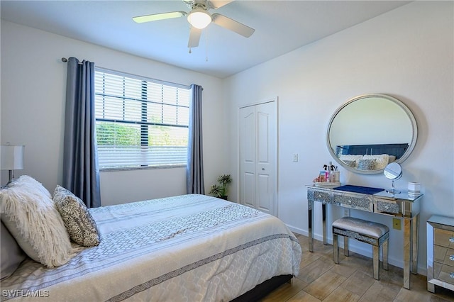 bedroom featuring wood finished floors, baseboards, a closet, and ceiling fan