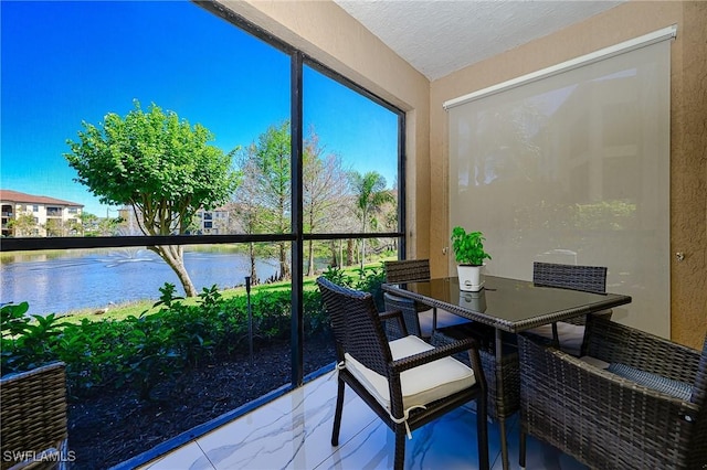 sunroom / solarium with a water view