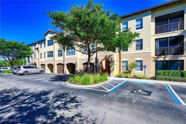 view of building exterior with uncovered parking