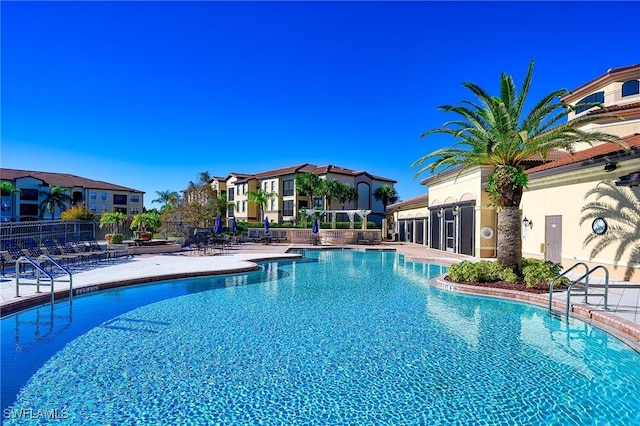 pool featuring a residential view, fence, and a patio area