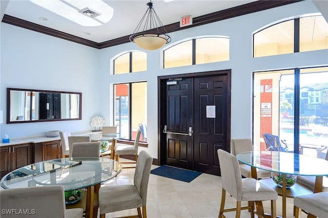 interior space featuring light tile patterned floors, visible vents, and crown molding