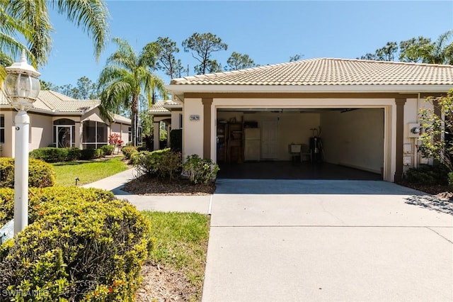 exterior space featuring a tile roof, concrete driveway, an attached garage, and stucco siding