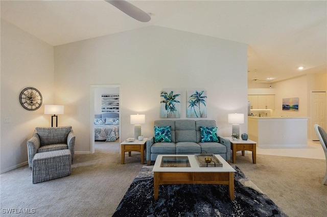 living room with baseboards, carpet floors, and high vaulted ceiling