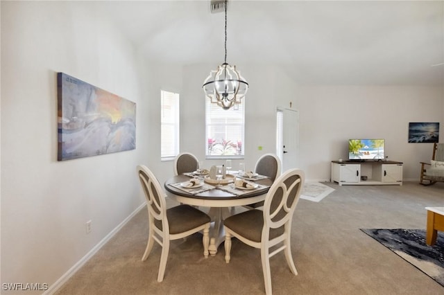 dining area with a chandelier, visible vents, light carpet, and baseboards