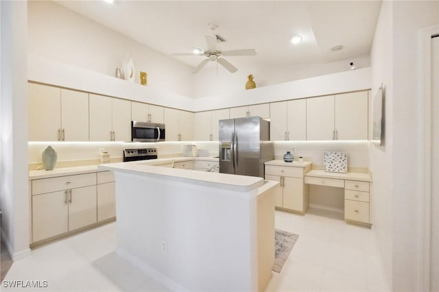 kitchen with a ceiling fan, a kitchen island, light countertops, a towering ceiling, and appliances with stainless steel finishes